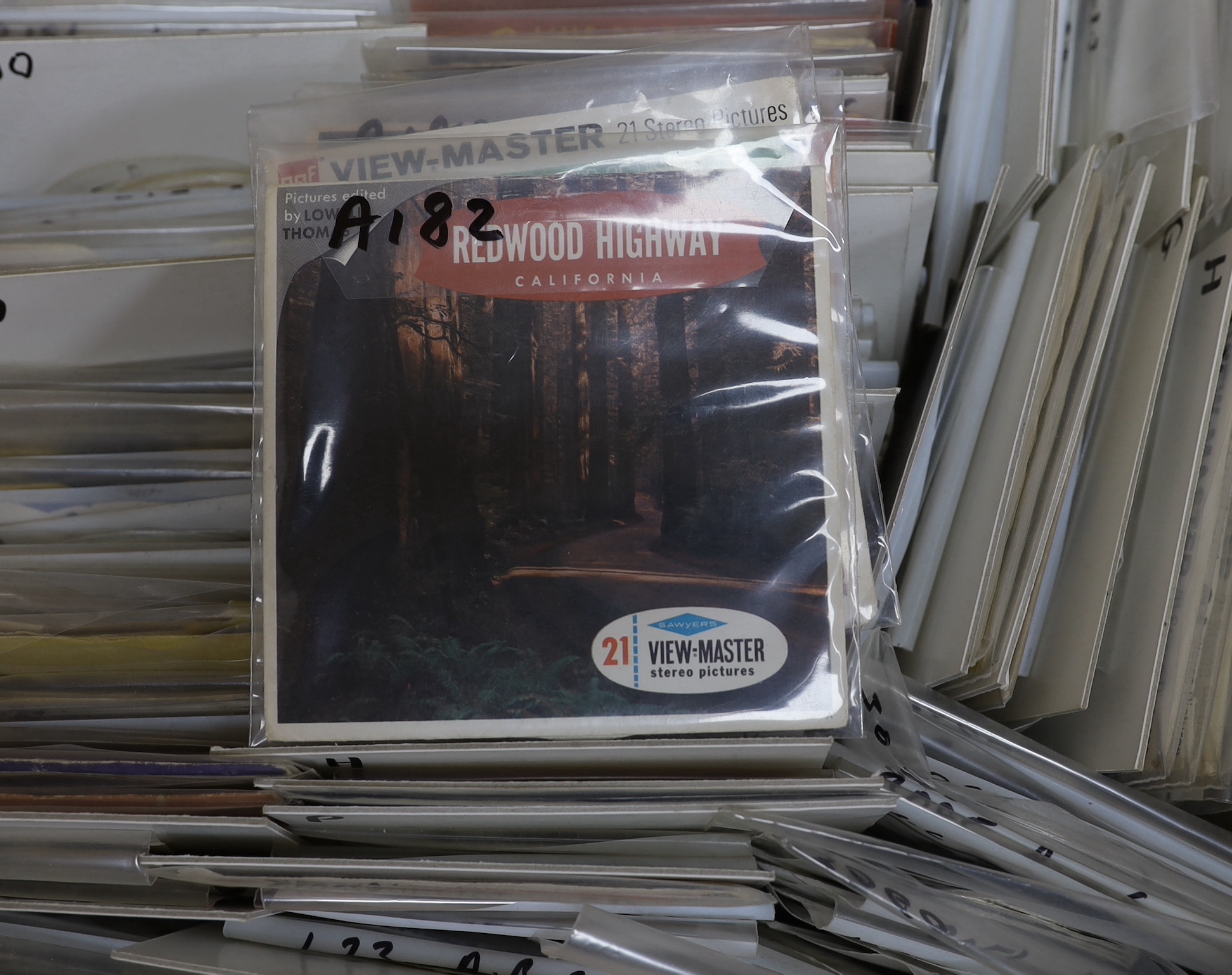 Fifteen View-Master viewers, including a large Mickey Mouse example, two ‘Model K’ viewers, one in red and another orange, together with a large quantity of reels with subjects including Natural History, National Parks,